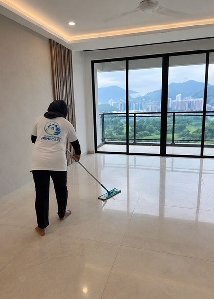 Cleaning Services Primecare cleaner mopping a high-rise condo living room