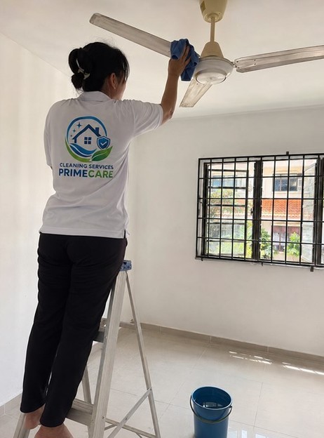 Cleaning Services Primecare cleaner wiping a ceiling fan at a Malaysian home