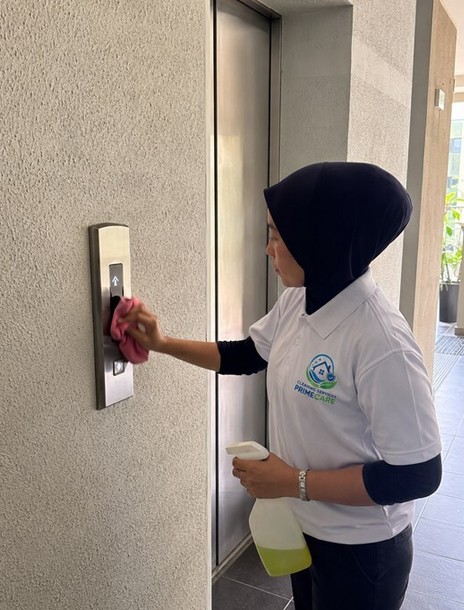 Janitorial services in Malaysia — Cleaning Services Primecare cleaner wiping lift panels in a commercial building